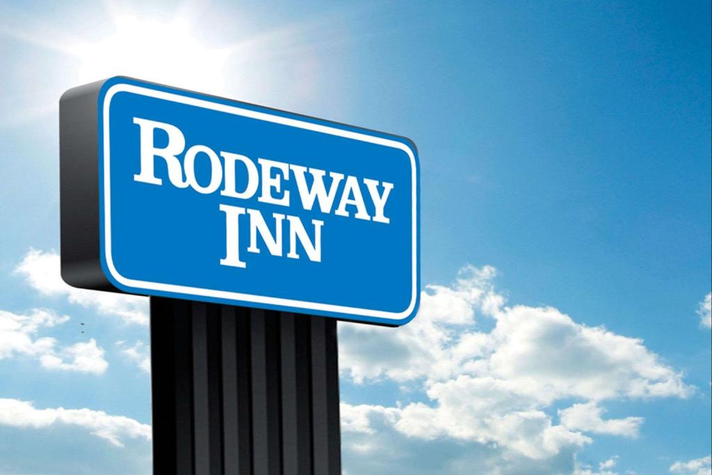 a blue street sign sitting on top of a pole at Rodeway Inn in Canton
