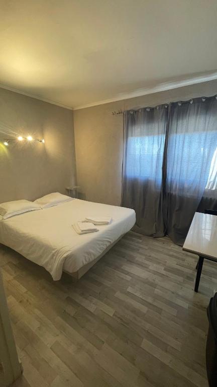 Postel nebo postele na pokoji v ubytování L'Excess Hotel