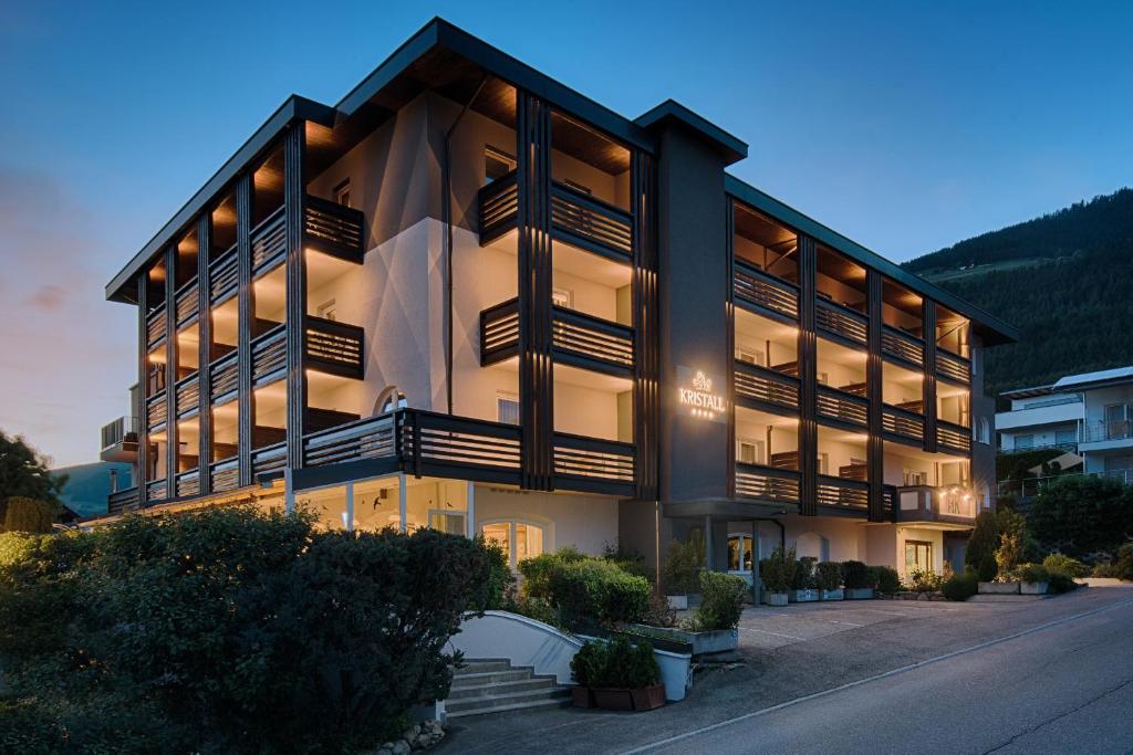 a large building with a lot of windows at Hotel Kristall in Falzes