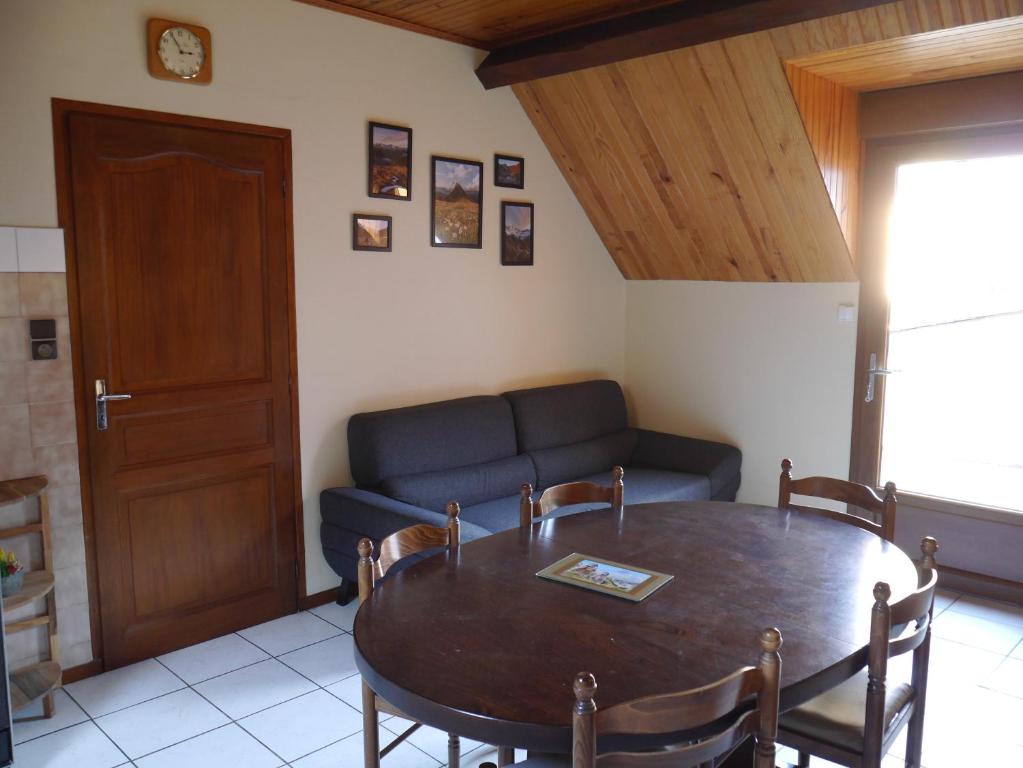a living room with a table and a couch at La Biasou in Gèdre