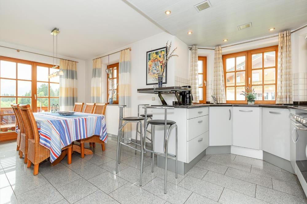 a kitchen with a table and a table and chairs at Ferienwohnung Anna in Reit