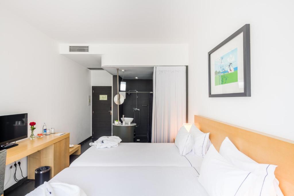 Uma cama ou camas num quarto em Boticas Hotel Art & SPA