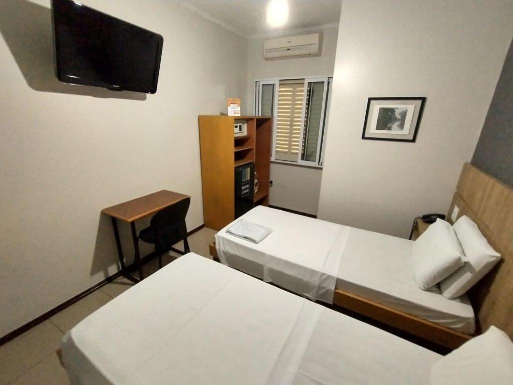 Postel nebo postele na pokoji v ubytování Hotel Cidade