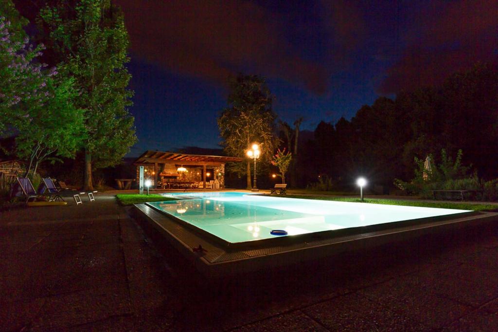 a large swimming pool in a yard at night at Villa Berrettini in Marano Vicentino