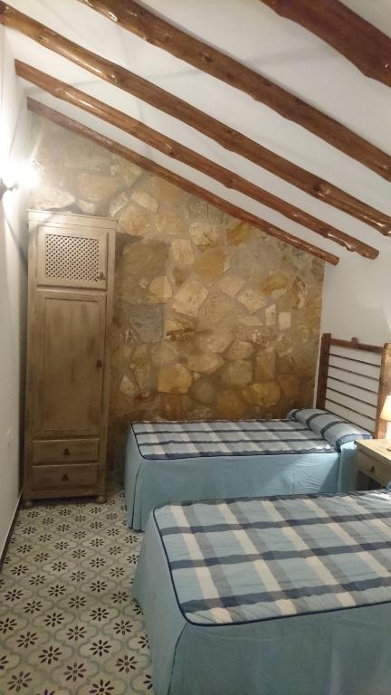 Łóżko lub łóżka w pokoju w obiekcie Casas Rurales Cortijos el Encinar