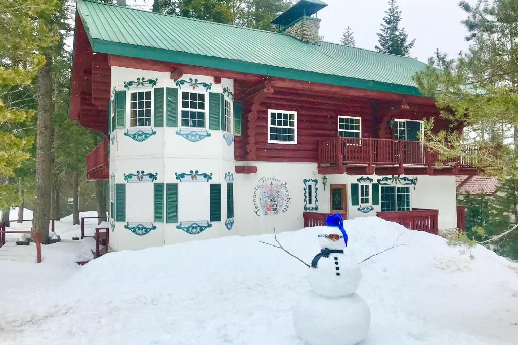 a snowman in front of a house in the snow at Vienna Villa - 3 Bed 3 Bath Vacation home in Shaver Lake in Shaver Lake