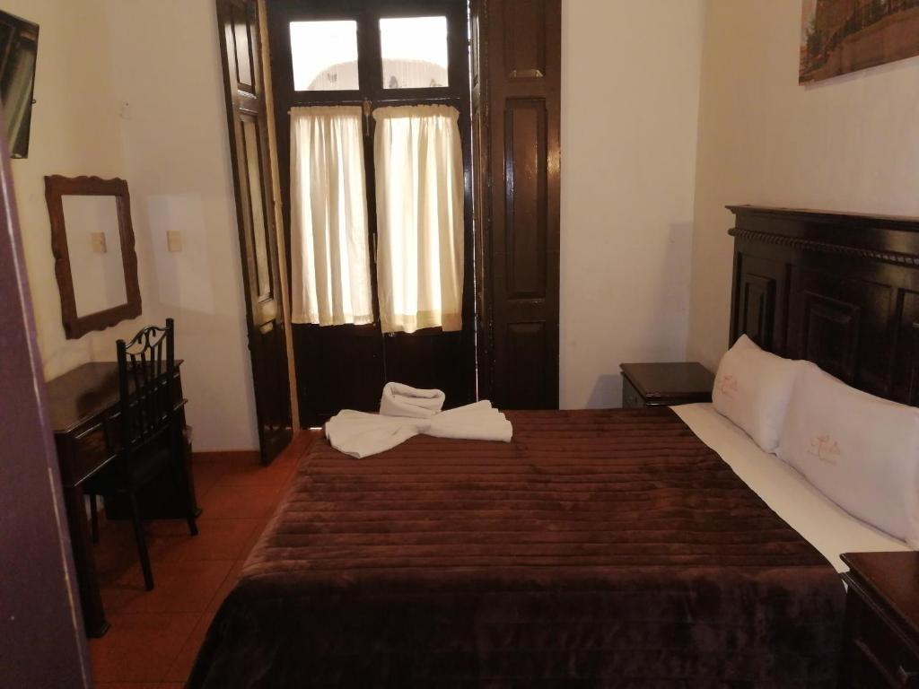 Postel nebo postele na pokoji v ubytování Hotel Colonial