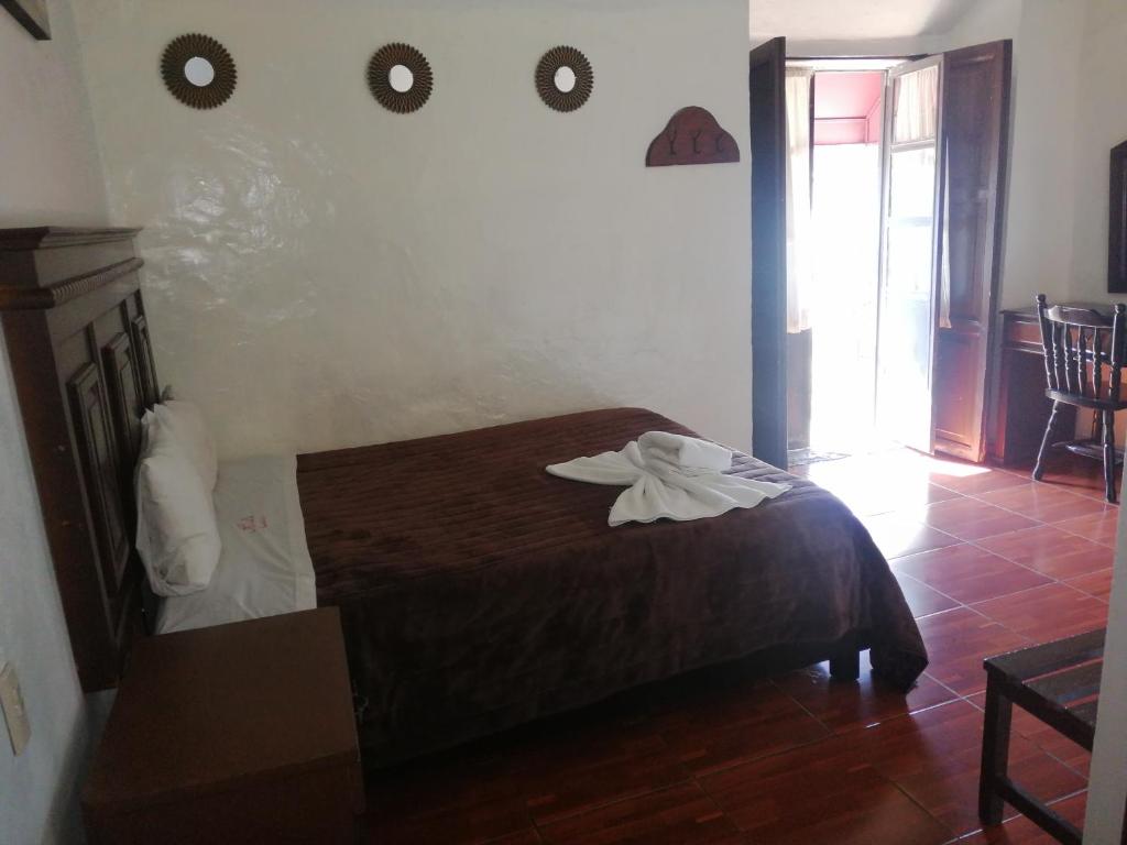 Postel nebo postele na pokoji v ubytování Hotel Colonial