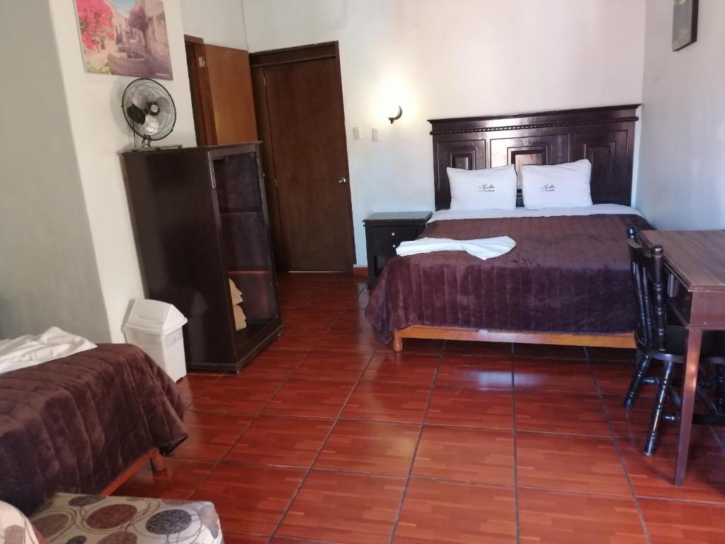 Postel nebo postele na pokoji v ubytování Hotel Colonial