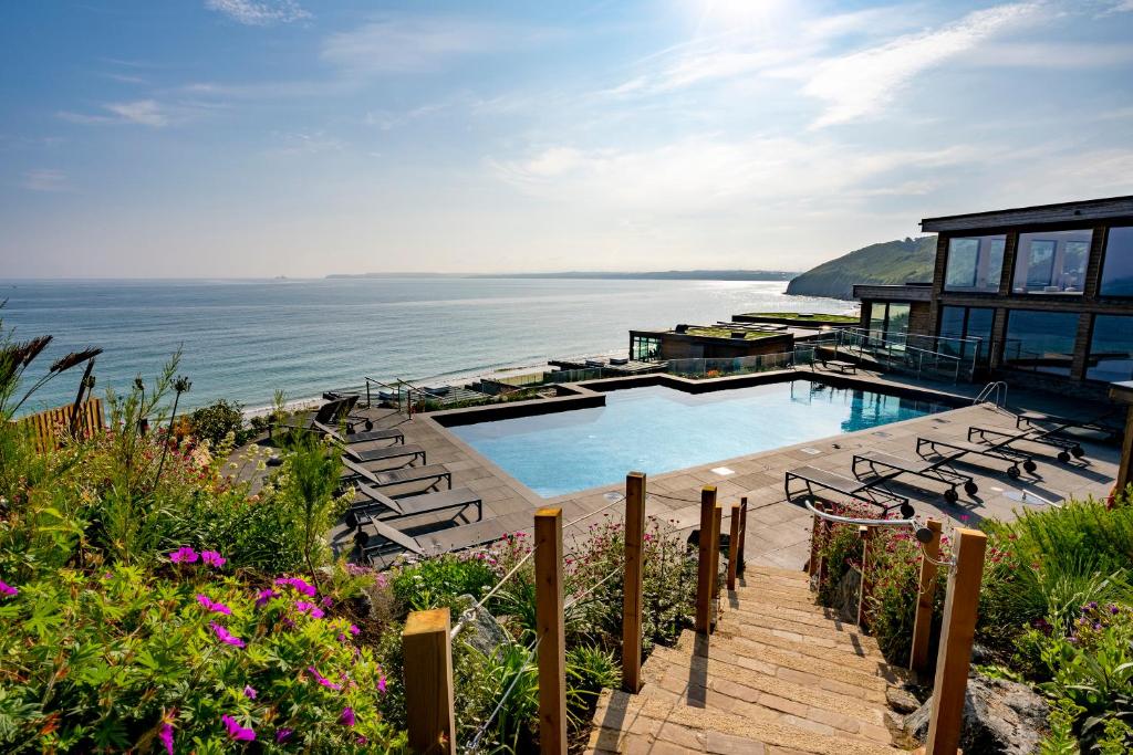 ein Haus mit einem Pool am Meer in der Unterkunft Carbis Bay and Spa Hotel in St Ives