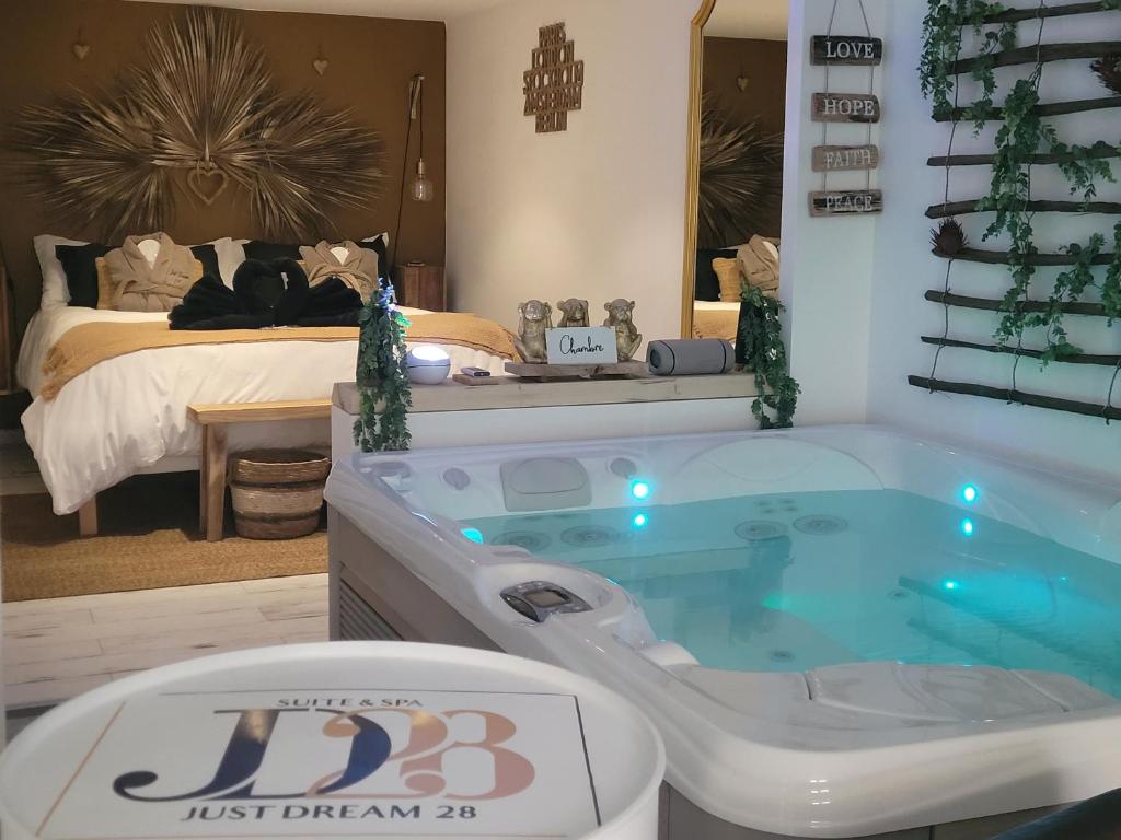 a hot tub in a bedroom with a bed at Suite & SPA Just Dream 28 in Six-Fours-les-Plages