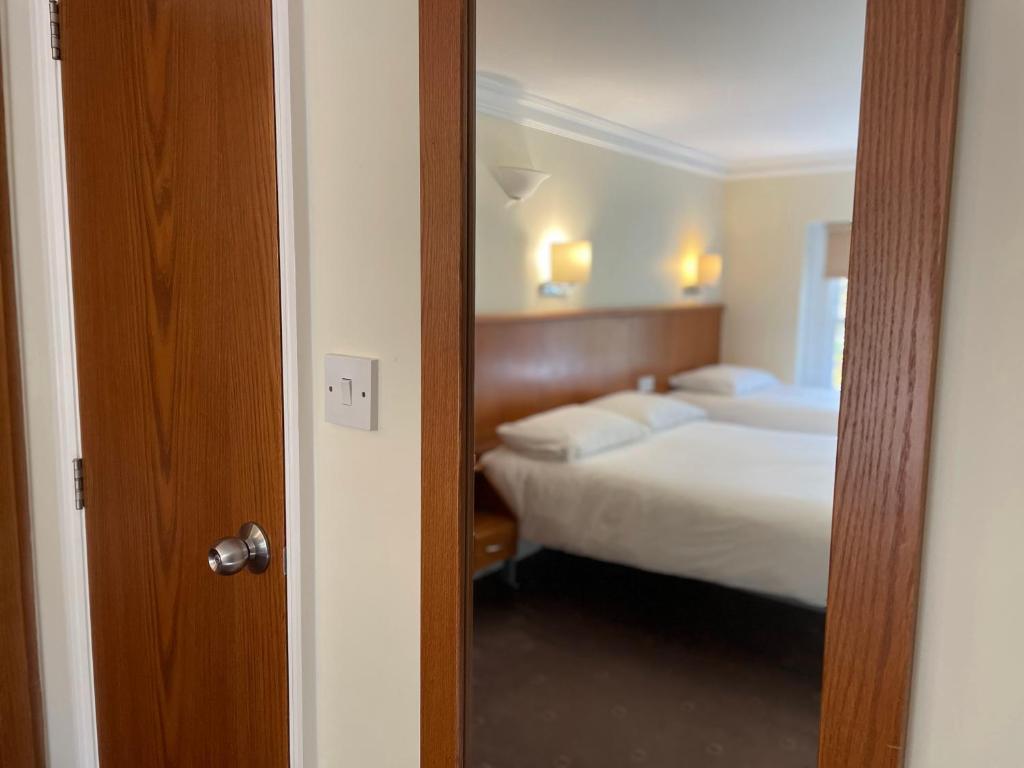 Postel nebo postele na pokoji v ubytování Orchard Hotel