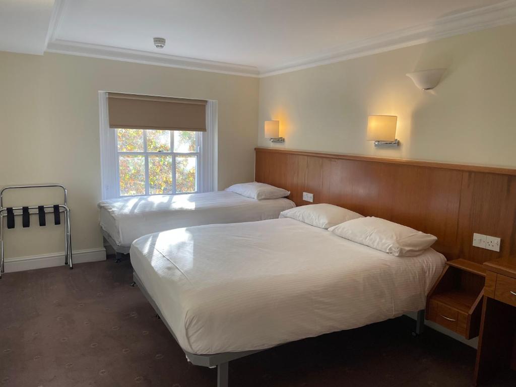 Postel nebo postele na pokoji v ubytování Orchard Hotel