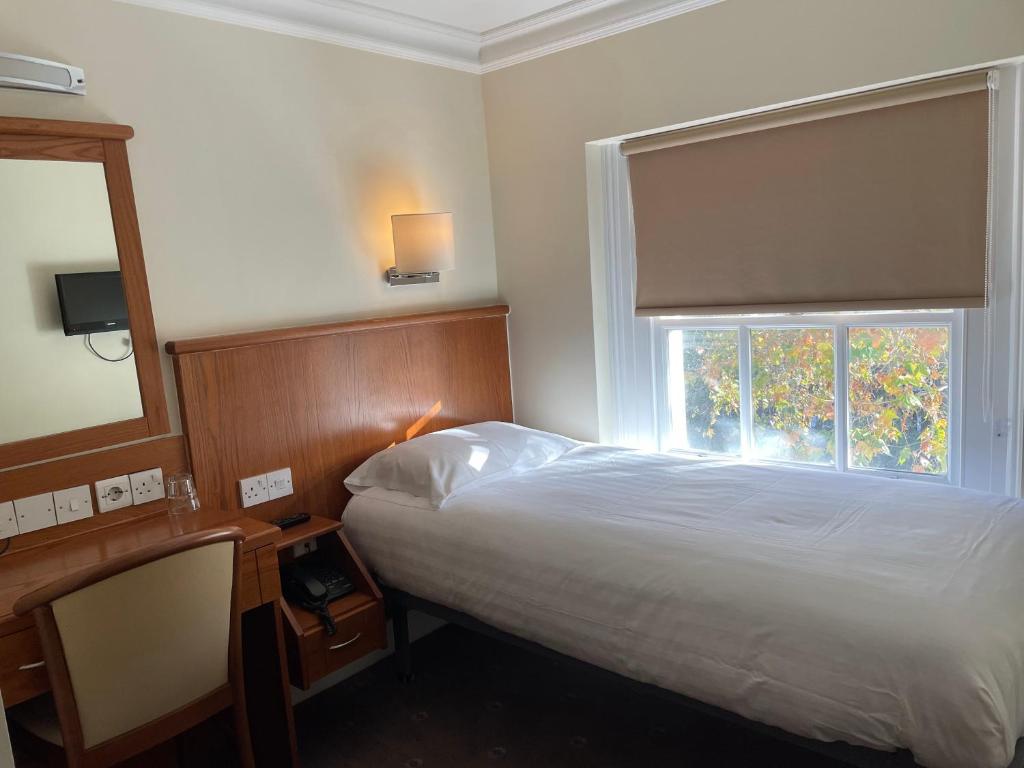 Postel nebo postele na pokoji v ubytování Orchard Hotel