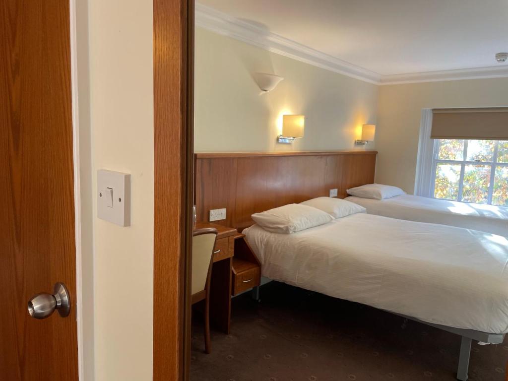 Postel nebo postele na pokoji v ubytování Orchard Hotel