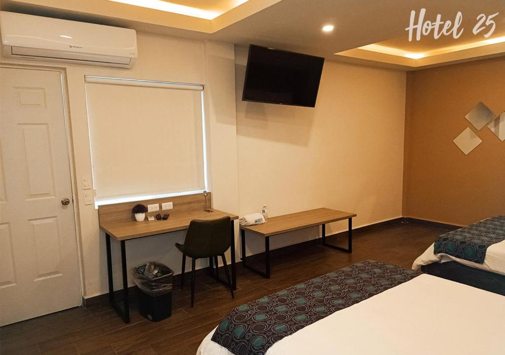 a hotel room with a desk and a chalkboard on the wall at Hotel25 in Monterrey
