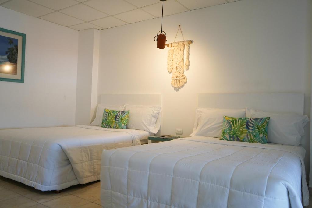 Postel nebo postele na pokoji v ubytování Hotel & Suites Arges - Centro Chetumal