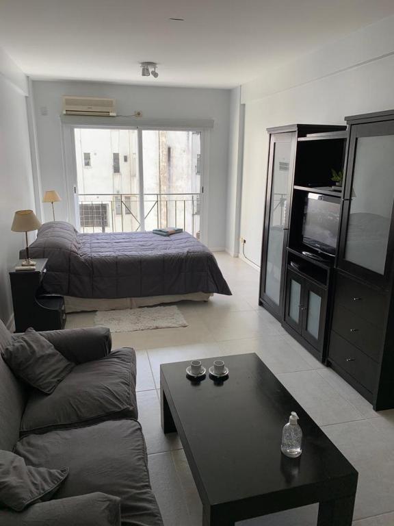 a living room with a bed and a couch at RECOLETA STUDIO in Buenos Aires