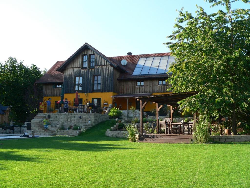 a large wooden house with a lawn in front of it at Reiterhof vom Litzlbach in Langquaid