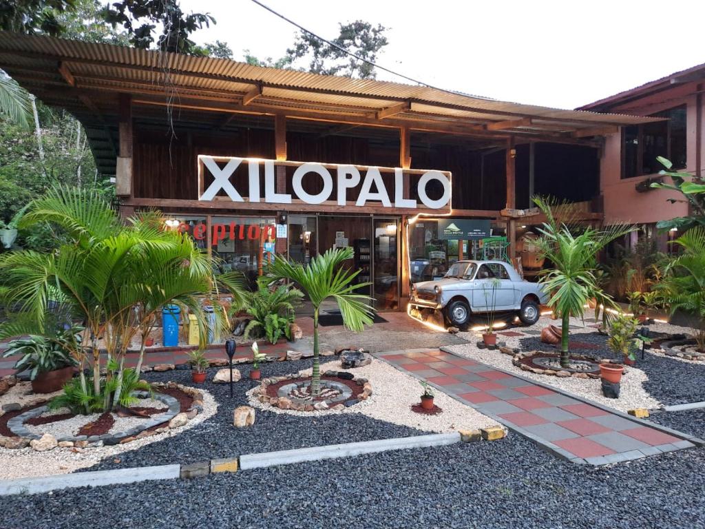 a white car parked in front of a store at Arenal Xilopalo in Fortuna