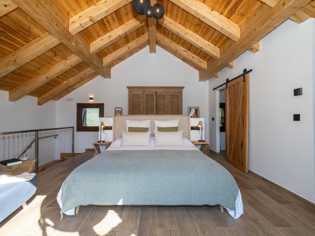 a bedroom with a large bed and wooden ceilings at Casa Rural "Las Eras" in Fanlo del Valle de Vío