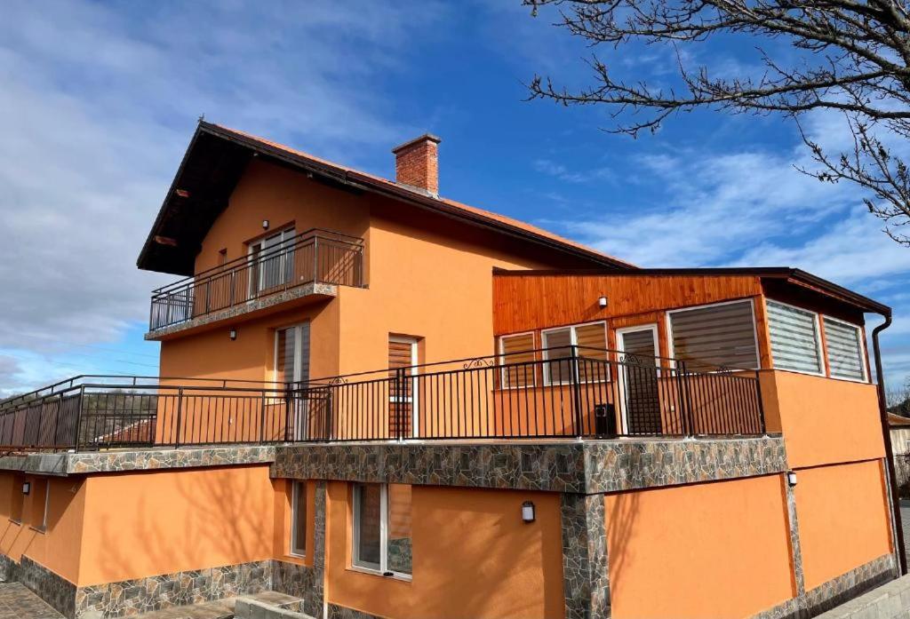 a orange house with a balcony on top of it at Villa Euphoria in Bersin