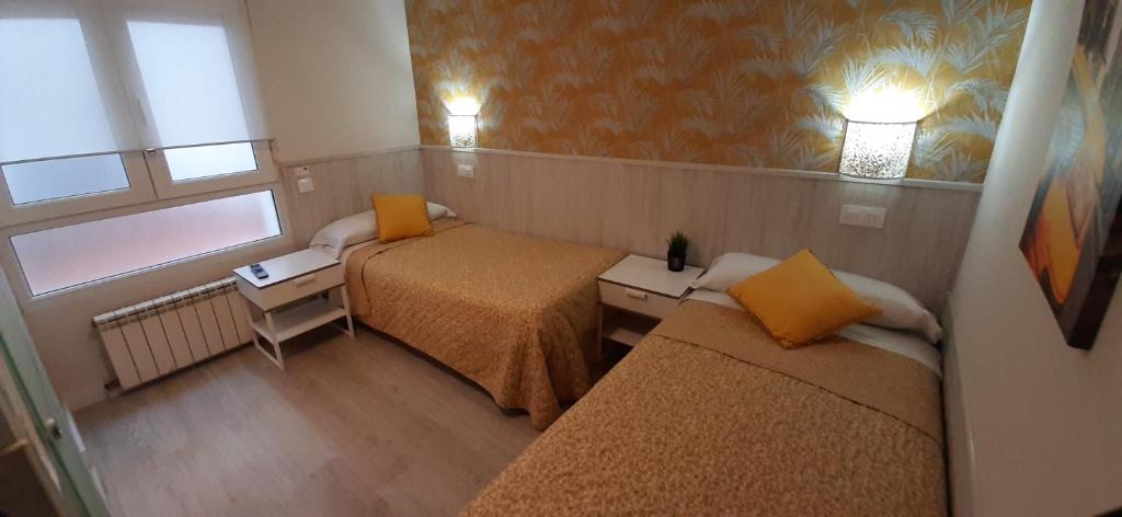 A bed or beds in a room at Hostal Verdemar