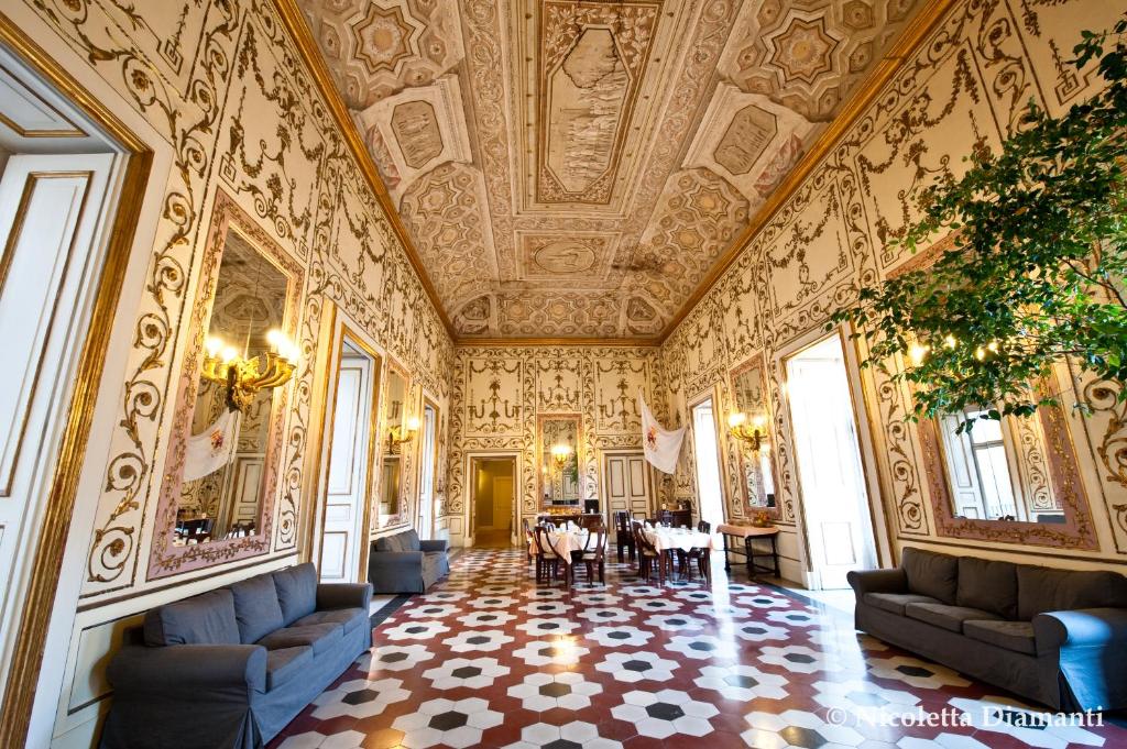 a large room with a ceiling and a dining room at Decumani Hotel De Charme in Naples