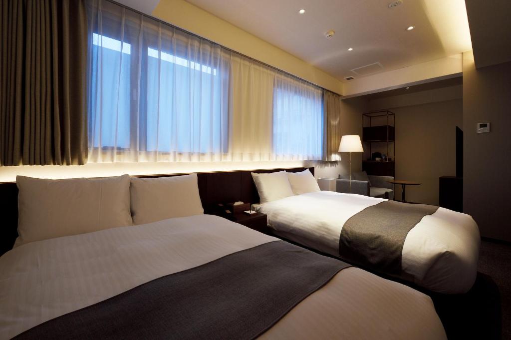 Postel nebo postele na pokoji v ubytování yoin hotel kyoto gion
