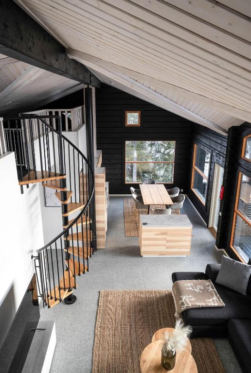 a living room with a couch and a table at Villa Ruka - Rising Sun with 3 bedrooms, loft, sauna and balcony with a view in Ruka