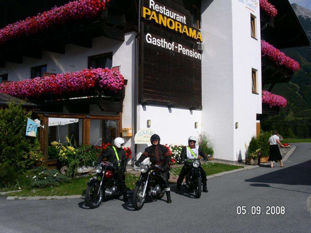 three people on motorcycles parked in front of a building at Gasthof Panorama in Obsteig