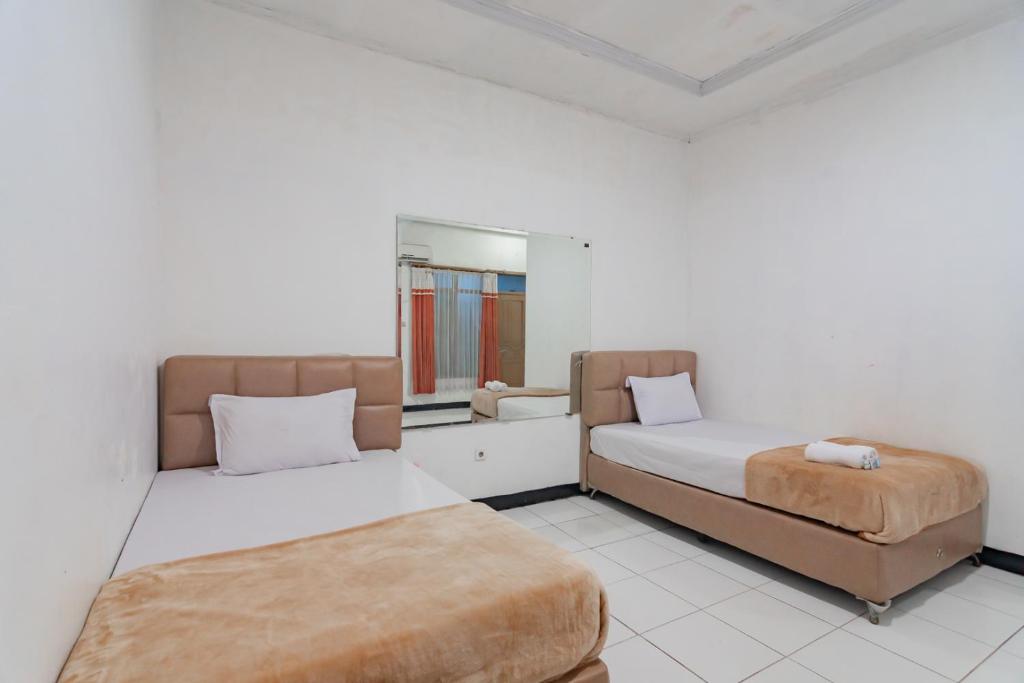 Postel nebo postele na pokoji v ubytování Hotel Markoni Pamanukan Mitra RedDoorz