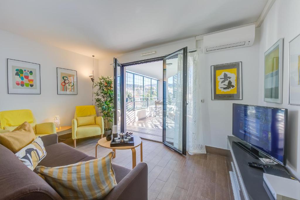 un salon avec un canapé et une télévision dans l'établissement Appartement Liberation, à Nice