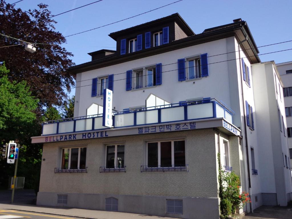 a large white building with a large window at Bellpark Hostel in Luzern