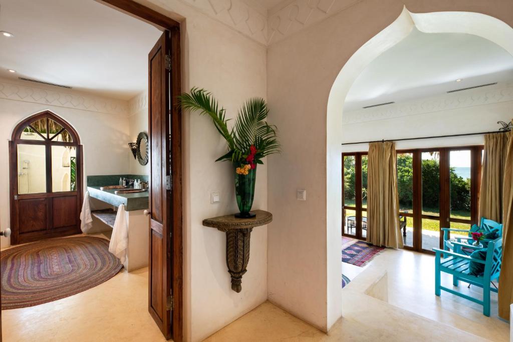 a living room with a hallway with a doorway at Qambani Luxury Resort in Michamvi