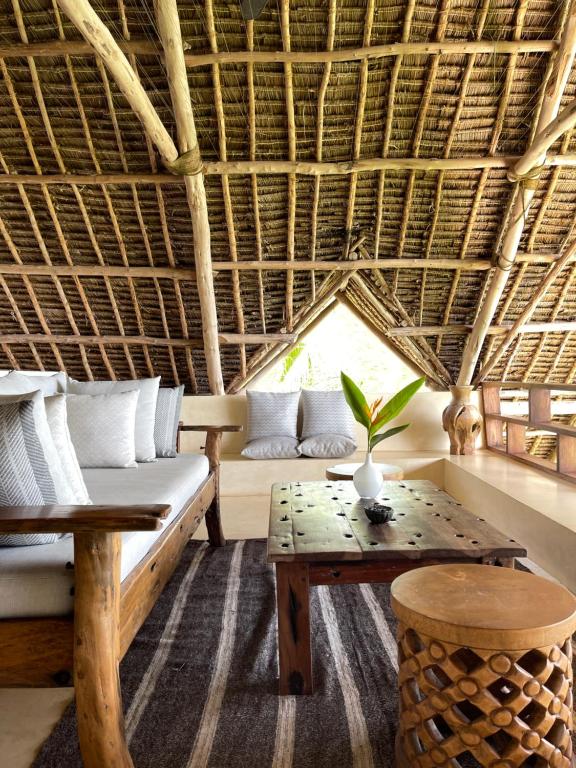 a living room with a couch and a table at Qambani Luxury Resort in Michamvi