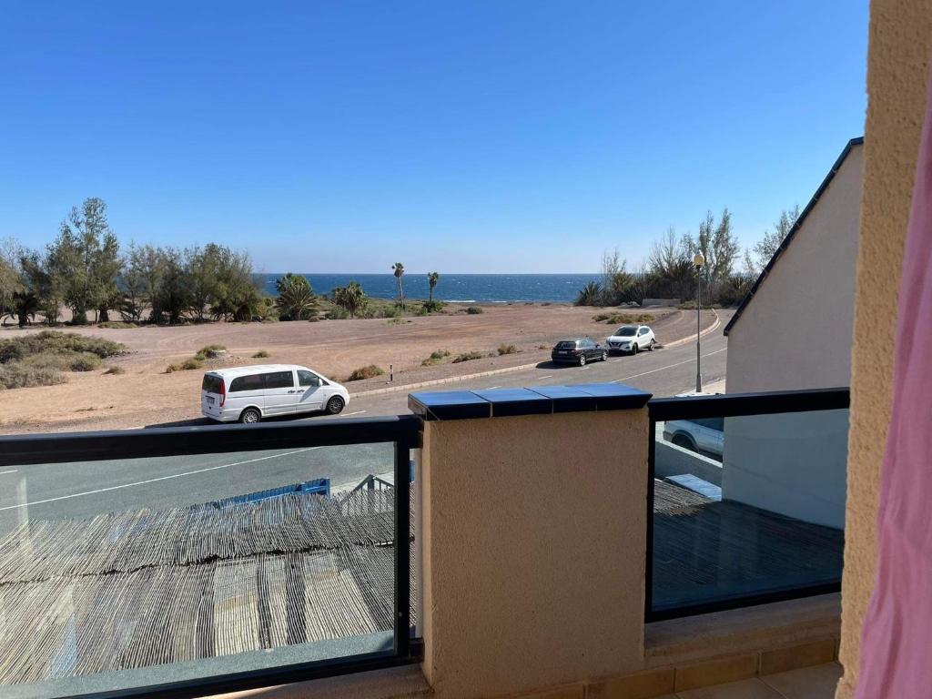 a balcony with a view of a road and the ocean at MiRA MAR in Lajita