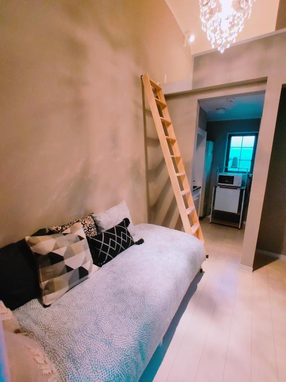 a bedroom with a bunk bed and a ladder at MeMe Inn - Vacation STAY 10900 in Saitama