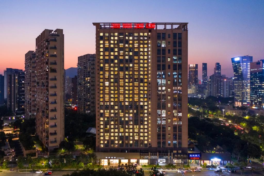 a tall building with lights on top of it at night at Shenzhen Bay Hisoar Hotel in Shenzhen