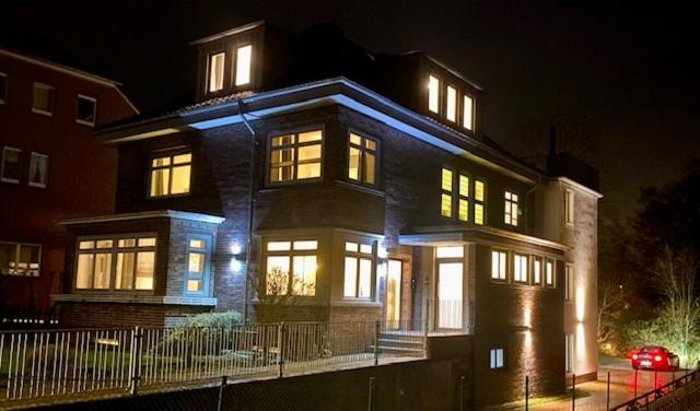 a large house with lit up windows at night at Villa Appartements Syke in Syke
