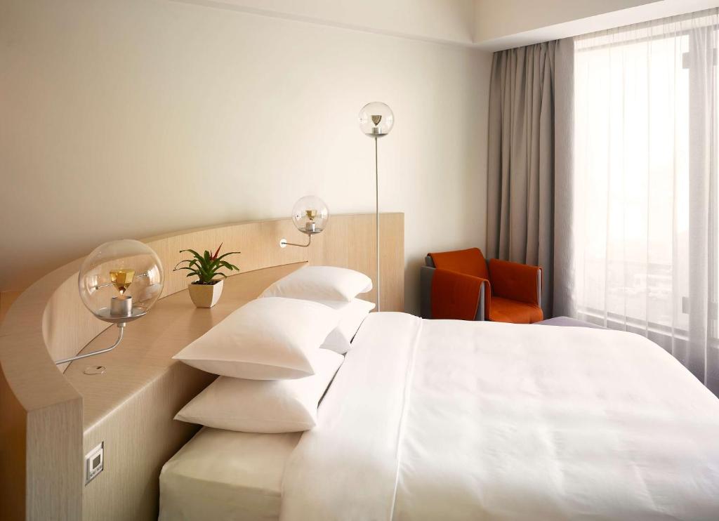 a hotel room with a bed and a desk at Hyatt Regency Ekaterinburg in Yekaterinburg