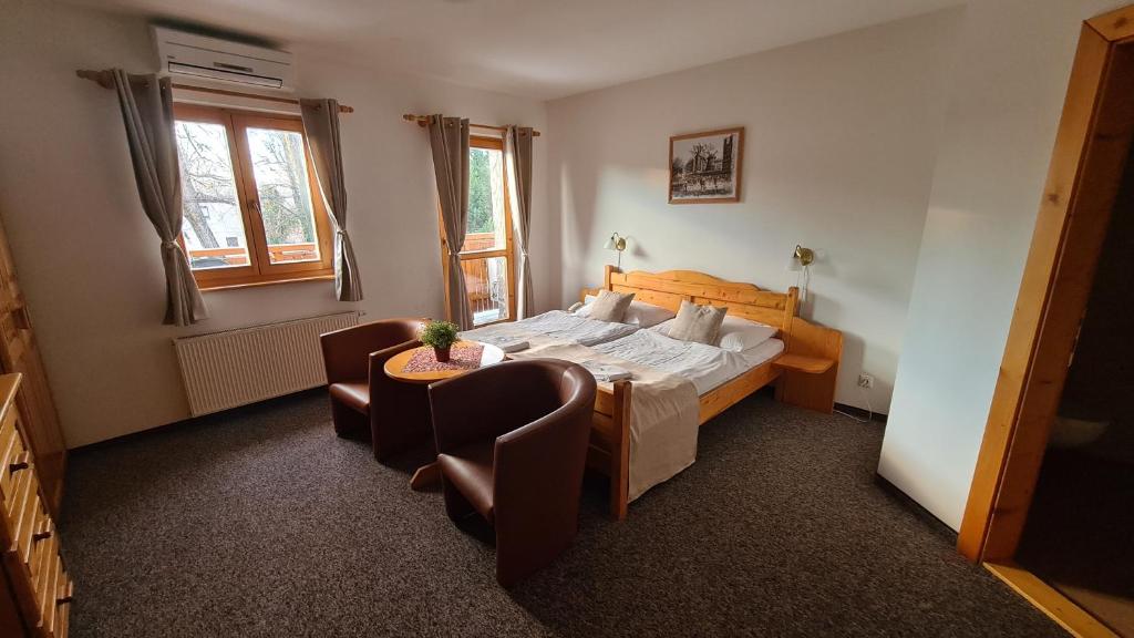 A bed or beds in a room at Hotel Koliba