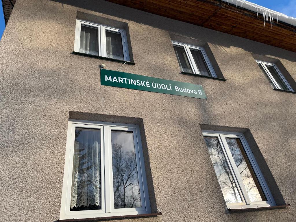 a building with a sign on the side of it at Pension Martinské údolí - dependance in Kořenov