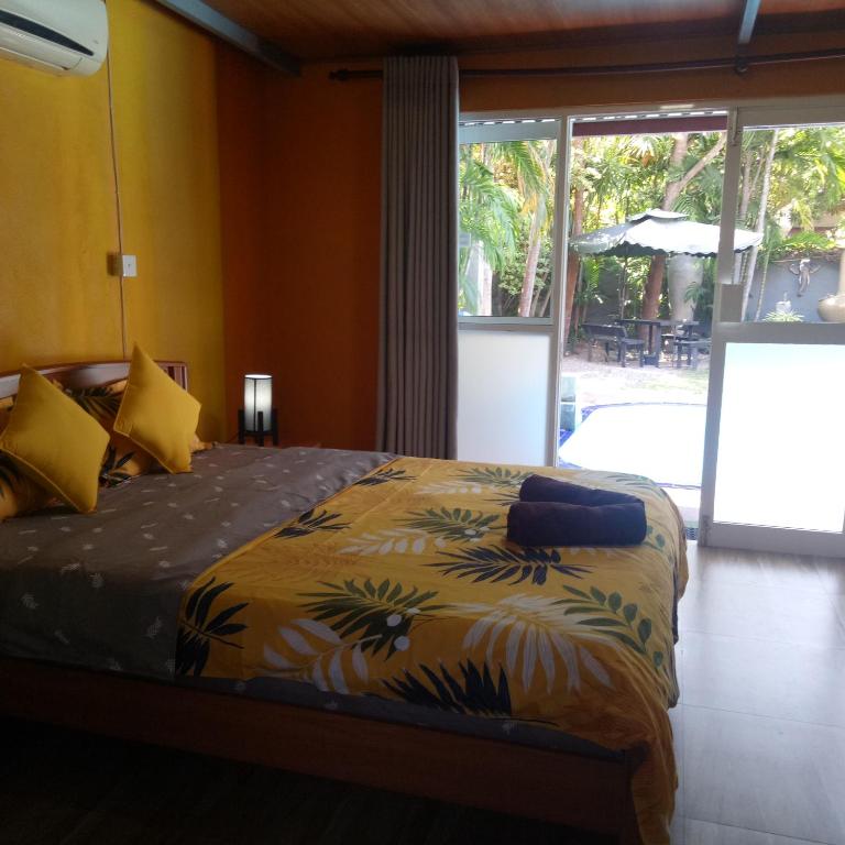Postel nebo postele na pokoji v ubytování Palms Villa