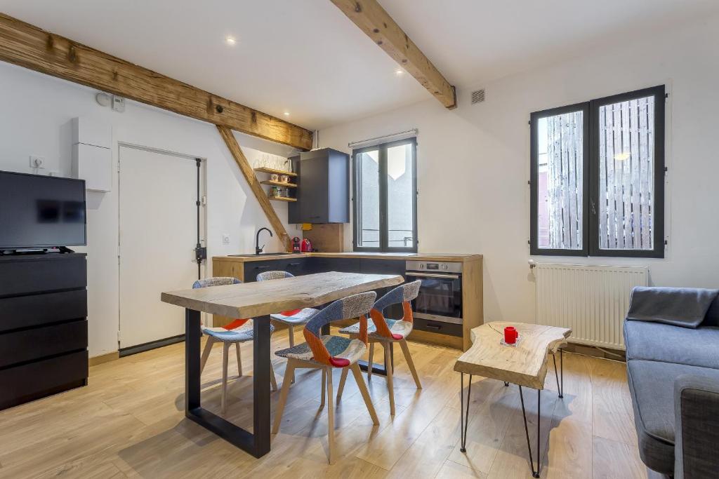 a kitchen and living room with a table and chairs at DIFY Tuileries - Valmy in Lyon