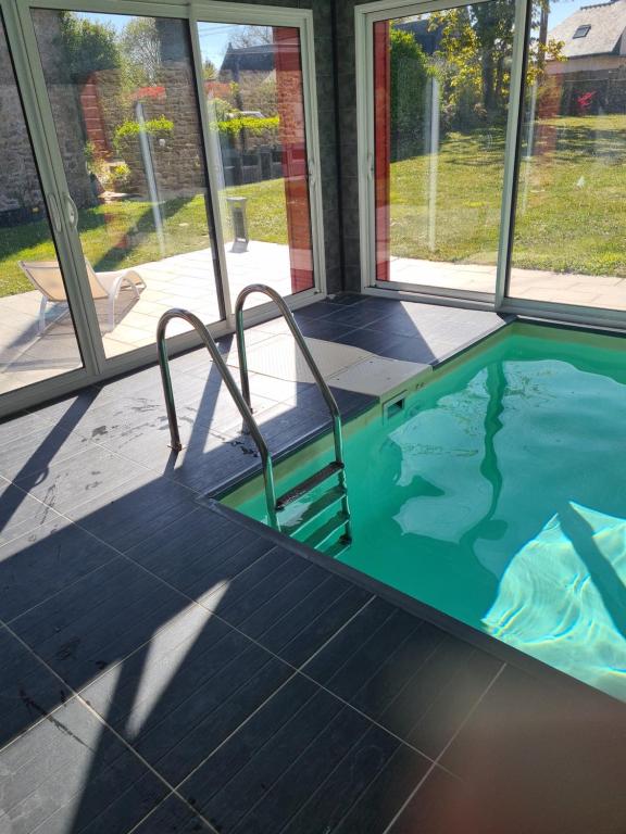 a swimming pool in a house with windows at Gîte Avalon - Closeries du Golfe in Theix