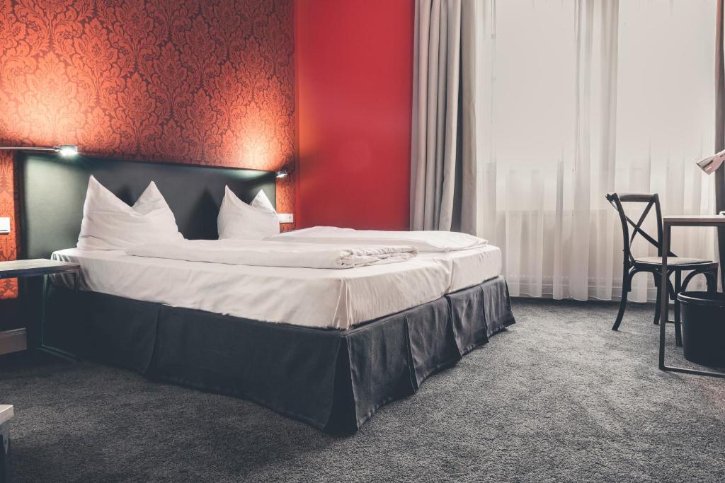 Ein Bett oder Betten in einem Zimmer der Unterkunft Hotel Deutschherrenhof