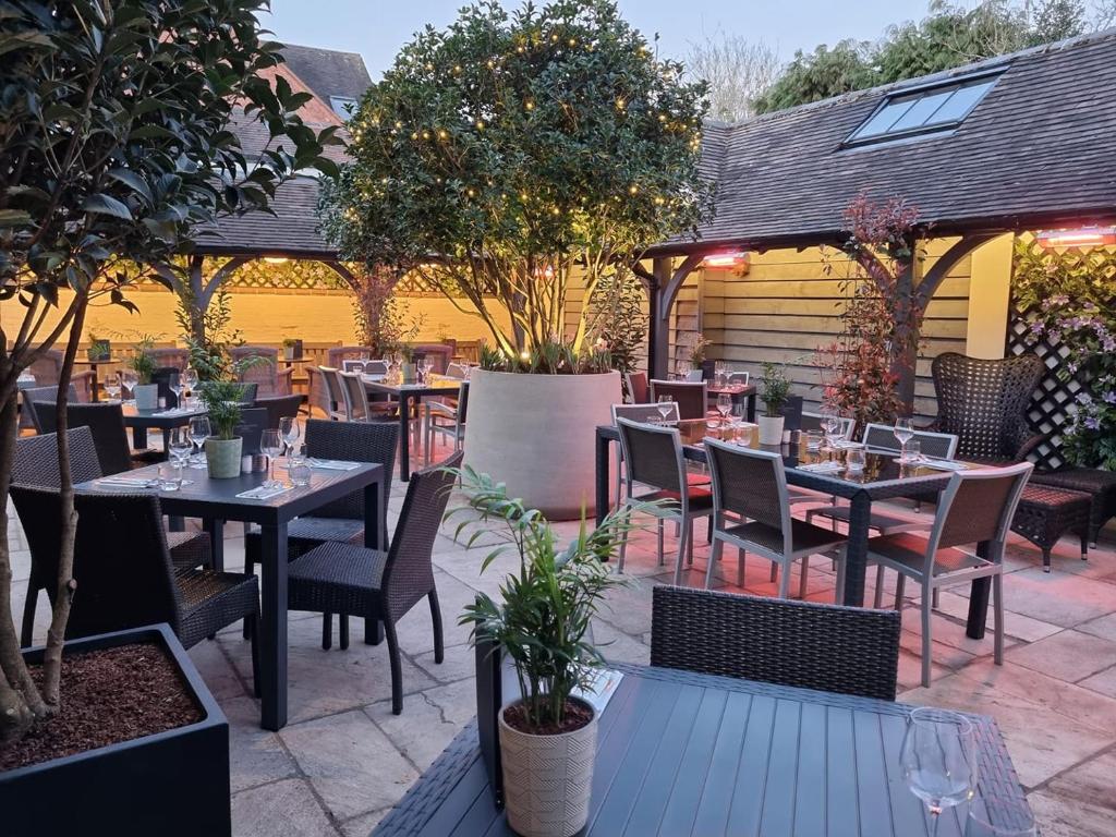 an outdoor dining area with tables and chairs at The Lion Hotel in Brewood