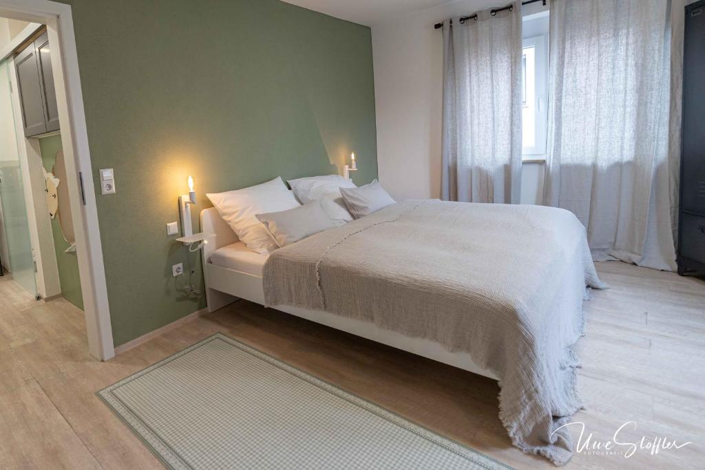 a bedroom with a large bed and a window at Sali Homes - Bergerie in Obersulm
