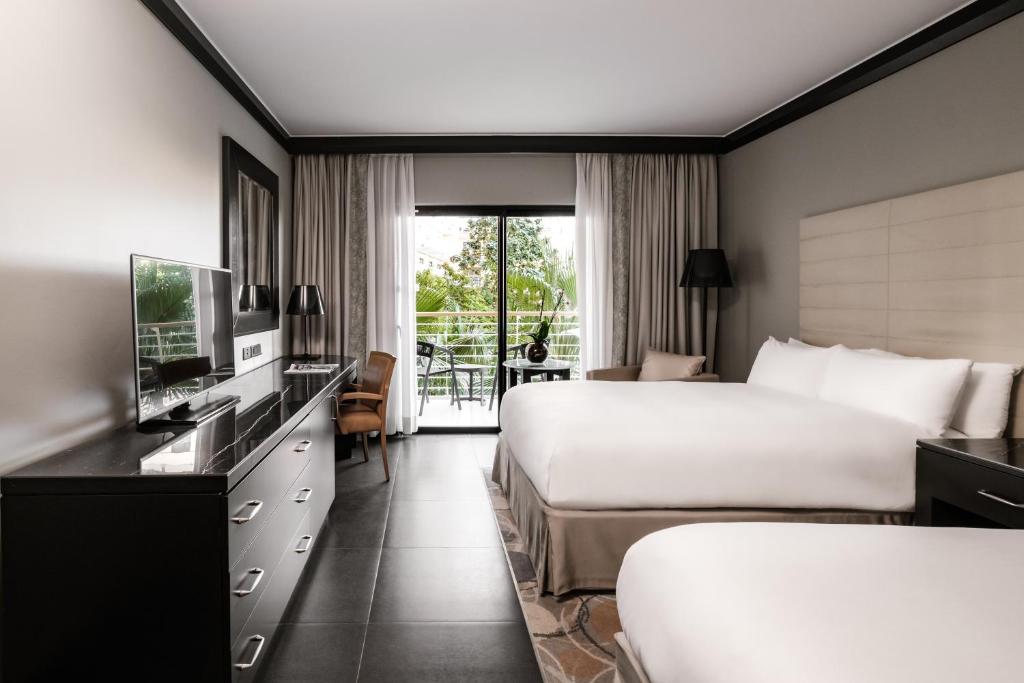 a hotel room with two beds and a television at InterContinental Malta by IHG in St Julian's